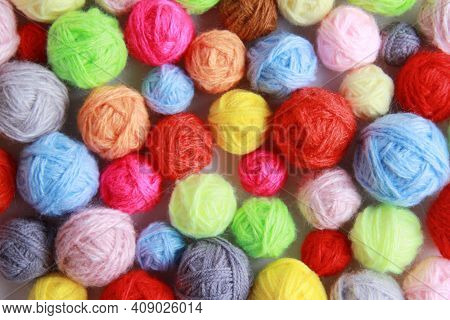 Colorful Background Of Multi-colored Yarn For Knitting, Crocheting. Lots Of Balls Of Yarn For Knitti