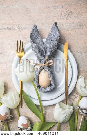 Easter Holiday Table Setting With Bunny  From Egg On White Plate And Tulips Flowers.  Gray Concrete 