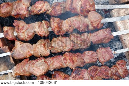Delicious Grilled Pork Meat In Bbq Barbecue With Pork Meat. Kebabs On The Grill. Close-up Of Meat On