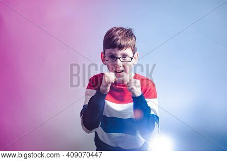 Portrait Of Young Boy In Warior Pose Holding Fists