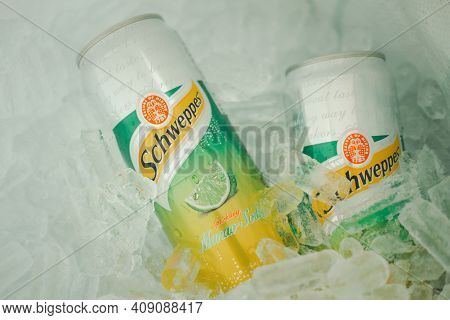 Bangkok, Thailand - February 21, 2021 : Two Can Of Schweppes Manao Soda In Basket With Ice Cube. Bev