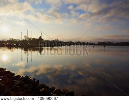 Magical Tranuil Beautiful With Clear Calm Water Sunset With Great Clouds Formation By The Sea Shore 