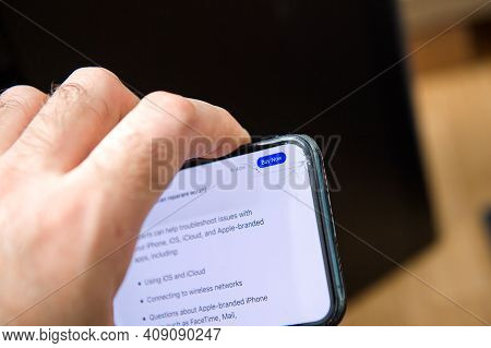 Paris, France - Jan 14, 2021: Male Hand Holding New Apple Computers Iphone 12 Pro Cracked Display - 