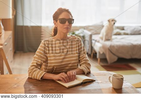 Warm Toned Portrait Of Modern Blind Woman Reading Braille Book While Sitting At Table In Cozy Home I