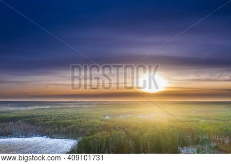 A Sunny Day, The Sun Is Shining In A Blue Cloudless Sky Low Above The Horizon. From The Height You C