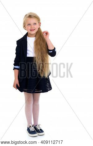 Cute Girl Elementary School Student. Cute Long Haired School Girl Wearing Blue Jacket And Skirt Posi