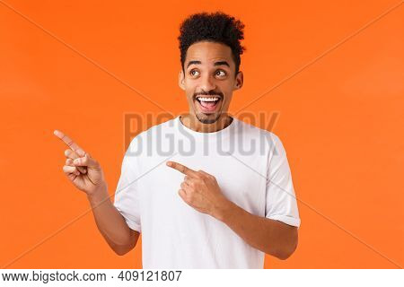 Excited, Happy Smiling African-american Man In White T-shirt, Looking Wondered And Astonished At Awe