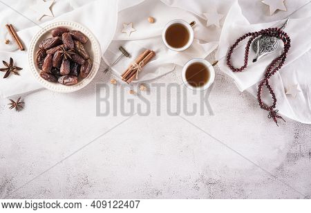Ramadan Food And Drinks Concept. Ramadan Arabian Lamp, Wood Rosary, Tea, And Dates Fruit On Dark Sto