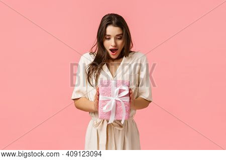 Amazement, Celebration And Holidays Concept. Surprised Girlfriend Holding Box Of Present, Didnt Expa