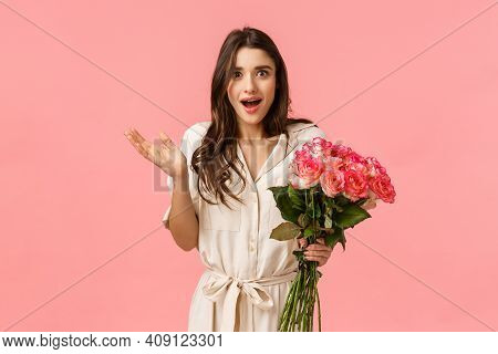 Surprised And Happy, Excited Pretty Young Woman Receive Flowers And Looking Astonished By Romantic N