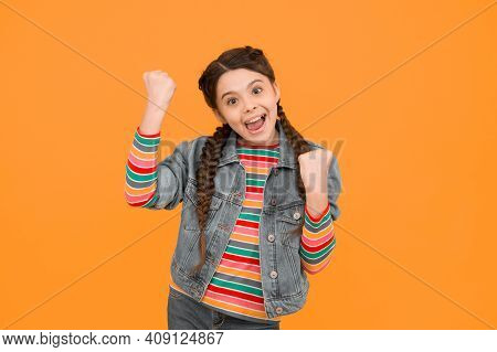 Always A Winner. Happy Little Winner Yellow Background. Small Girl Make Winner Gesture. Celebrating 