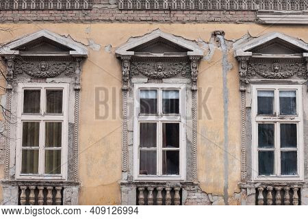 Old Windows On The Residential Building Of The Urban Area Of Belgrade Serbia, With A Damaged And Dec