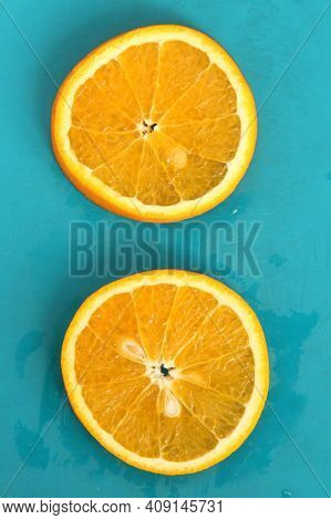 Close Up Of Two Round Orange Citrus Slices On Blue Background, Fresh Summer Mood. Stock Photo Blank 