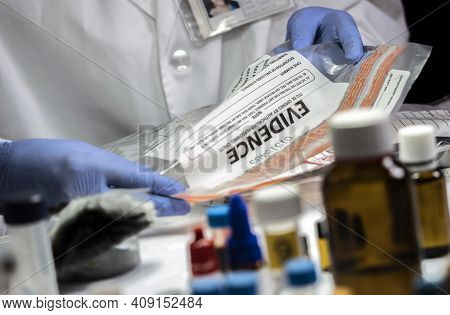 Police Specialized Taking Sample Of A Bag Of Evidence In Forensic Laboratory, Conceptual Image