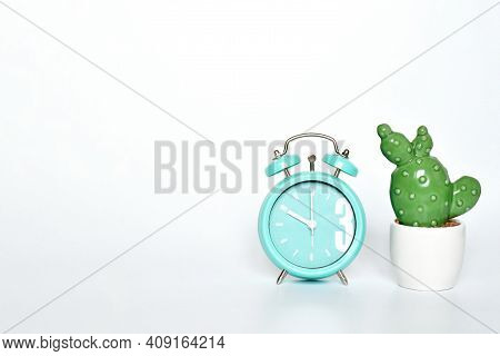 Selective Focus Ceramic Cactus And  Green Mint Vintage Clock Show 10 O'clock Put On White Gray Backg