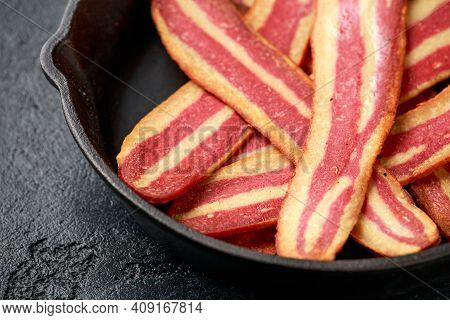 Fried Crunchy Plant Based Vegan Bacon Pieces In A Cast Iron Skillet