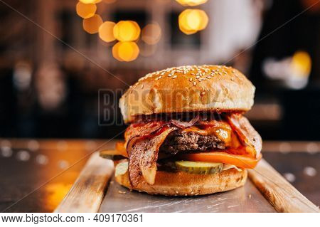 Elicious Burger With Sauce. Hamburger. Delicious Grilled Angus Burger With Cheese, Salad And Tomatoe