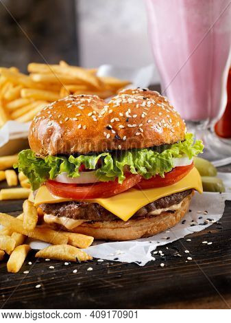 Elicious Burger With Sauce. Hamburger. Delicious Grilled Angus Burger With Cheese, Salad And Tomatoe