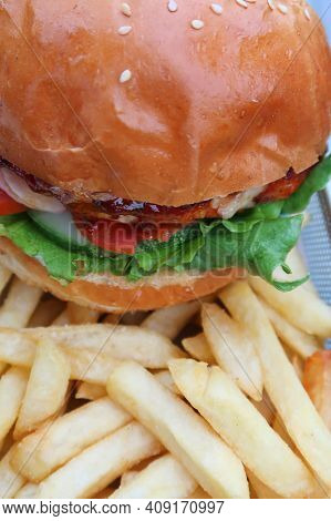 Elicious Burger With Sauce. Hamburger. Delicious Grilled Angus Burger With Cheese, Salad And Tomatoe