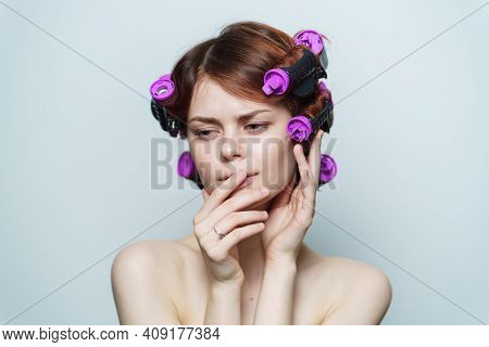 Wind Curls Of Hair Purple Curlers On The Head Of A Red-haired Woman