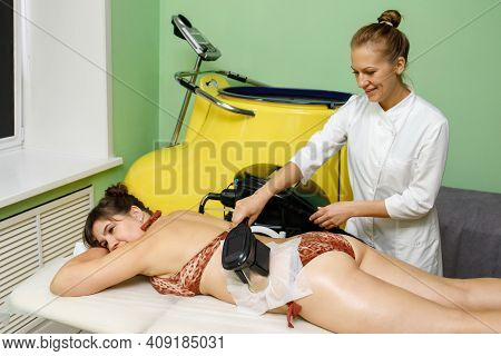 Woman Getting Cryolipolysis Fat Treatment Procedure In Beauty Salon