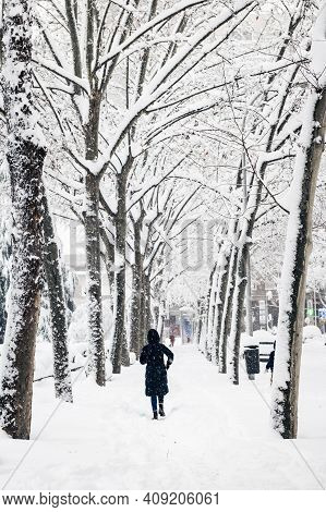 Madrid - January 9, 2021: A Lonely Woman Takes A Picture With Her Smartphone In A Park In Madrid Dur