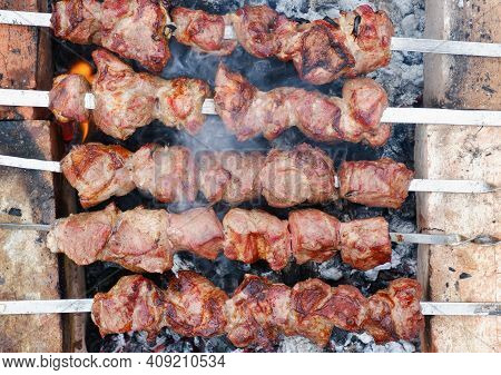 Delicious Grilled Pork Meat In Bbq Barbecue With Pork Meat. Kebabs On The Grill. Close-up Of Meat On