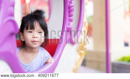 Happy Child Asian Girl Sweet Smile. Candid Kids Sitting On The Carousel. It Is A Leisurely Time Afte