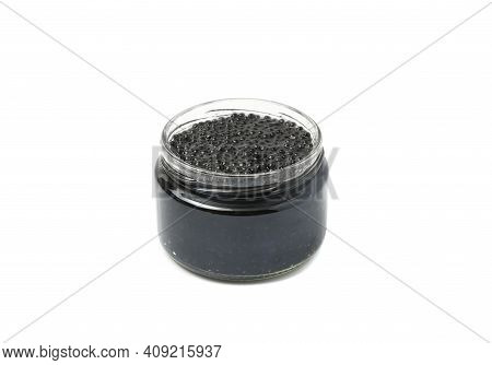 Black Caviar In A Glass Jar. Isolated On White Background.