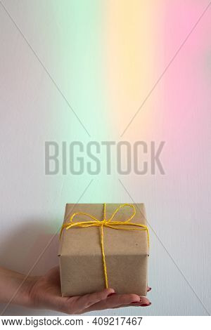 Gift Box. Magic Holiday Surprise. Fast Delivery. Female Hand Holding Wrapped Present Taped Yellow Ro