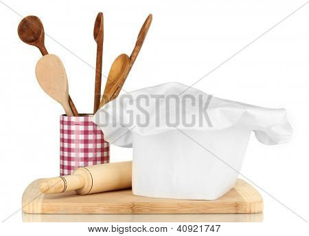 Kochmütze mit Löffel und Federballschläger, isolated on white