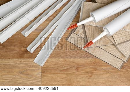 Set Of Items For Pvc Ceiling Indoor Works. Assembly Adhesive Bottles And Pvc Panels With Plastic Cor
