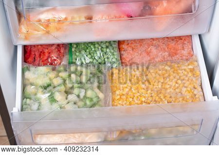 Assortment Of Frozenvegetables In Home Fridge. Frozen Food In The Freezer
