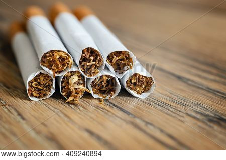 Close Up Of A Hndmade Smoking Cigarettes On Wooden Background