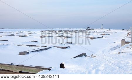 The Frozen In Slips At The Private Marina At Lighthouse Point, In Collingwood, Sits Empty All Winter