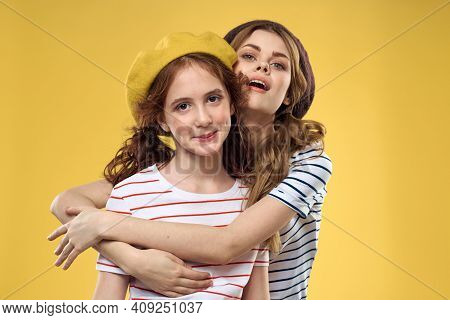 Mom And Daughter Embrace Joy Fun Childhood Lifestyle Yellow Background