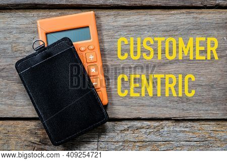 Top View Of Name Tag, Calculator On Wooden Background Written With Customer Centric