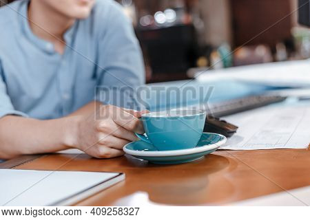 Architecture And Cup Of Coffee On Office Desk In Engineer Romm.