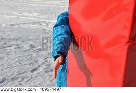 The Child Hits The Foam Barrier At High Speed On A Pole Near The Ski Slope. Safety Protection Of An 