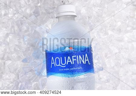 IRVINE, CALIFORNIA - JANUARY 22, 2017: Aquafina Water Bottle on ice. The purified water brand is produced by PepsiCo, in both flavored and unflavored varieties.