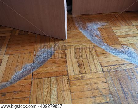 Scratched Parquet Flooring In The Room. Scratches, Chips And Dents On The Floor. Parquet In Need Of 