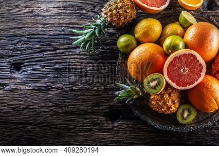 Top View Of Exotic Fruit And Citruses On A Vintage Wood.
