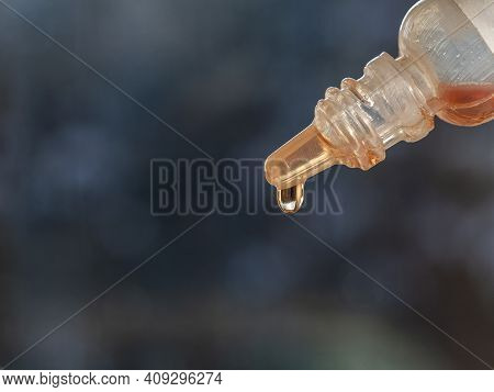 A Remedy For Diseases Of The Eyes, Nose Or Ears. A Drop Of Liquid Medicine Hangs At The Tip Of The B