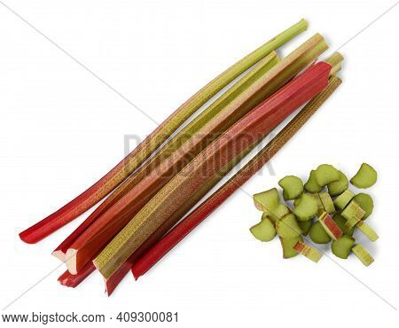Bundle Of Thick Reddish Stalks Of Rhubarb (rheum Rhaponticum) Without Leaves And Cut Pieces Isolated