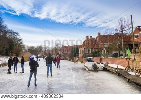 Winsum, Netherlands - February 14, 2021: People Skating On The Winsumerdiep River In Winsum, Netherl