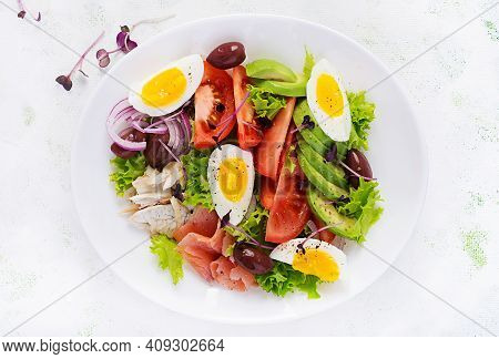 Ketogenic Diet Breakfast. Salt Salmon And Baked Dorado Salad With Greens, Tomatoes, Eggs And Avocado