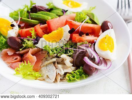 Ketogenic Diet Breakfast. Salt Salmon And Baked Dorado Salad With Greens, Tomatoes, Eggs And Avocado