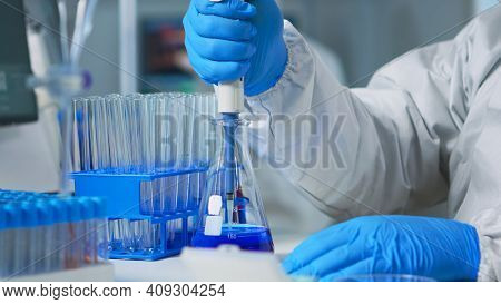 Close Up Of Researcher Testing Liquid Sample Using Micropipette For New Treatment Medical Laboratory