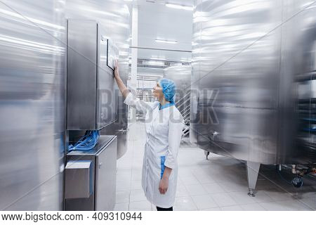 Worker Female Operator In Uniform Uses Process Control Panel Food Factory Production Line And Steel 