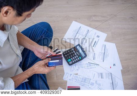Businessman Or Butler Is Sitting At The Press Of Various Expense Calculators On Invoices And Credit 